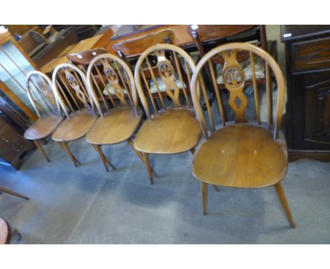 A set of five Ercol Golden Dawn elm and beech fleur de lys chairs 