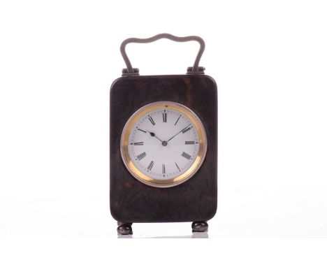 An Edwardian silver-mounted tortoiseshell travel timepiece, London 1907 by William Comyns, the plain rectangular case with si