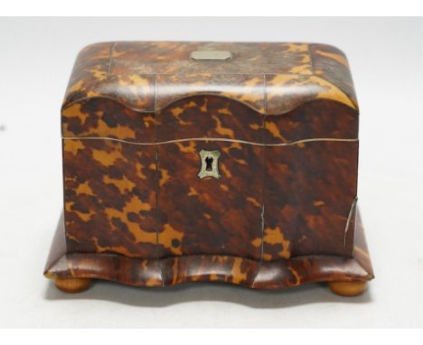 A Regency tortoiseshell tea caddy with inlaid silver and ivory stringing, on later bun feet, 12cm high. CITES Submission refe