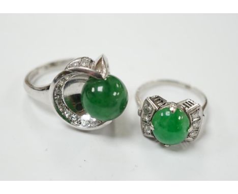 A modern white metal (stamped Pt) and jade bead set ring, with diamond set shoulders, size J/K, together with a similar large
