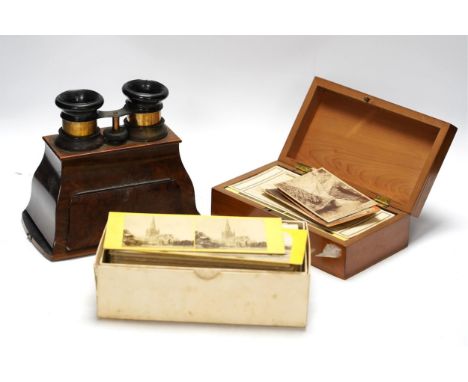 A late 19th century cased stereoscopic viewer together with topographical and other cards. Condition - fairBurr walnut viewer