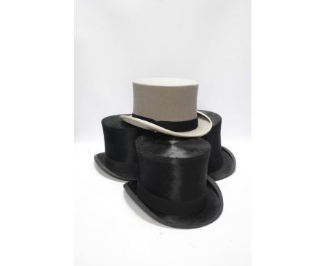 Three gentlemen’s black silk top hats and a similar grey top hat and box. Condition - grey hat good, others poor Moss Bros. g