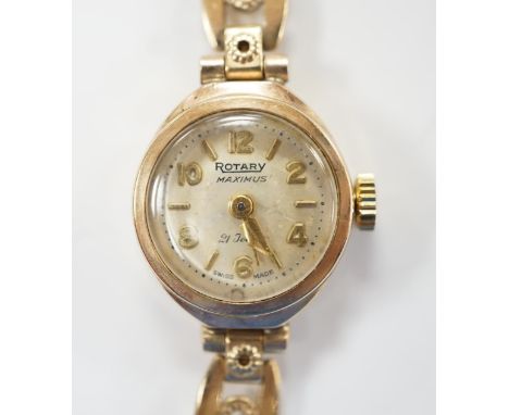 A lady's 9ct gold Rotary Maximus manual wind wrist watch, on a rolled gold bracelet. Condition - fair
