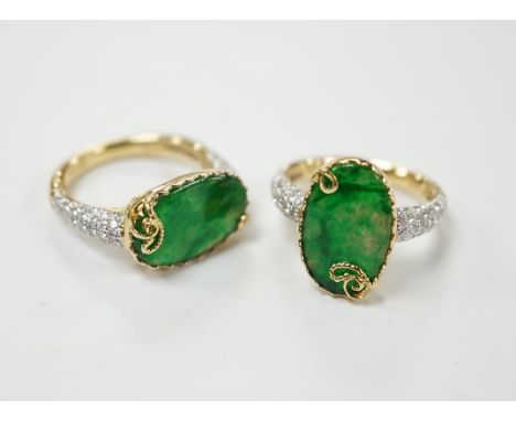 Two similar modern 18k and oval jade set dress rings, with diamond chip set shoulders, sizes K &amp; L, gross weight 9.9 gram