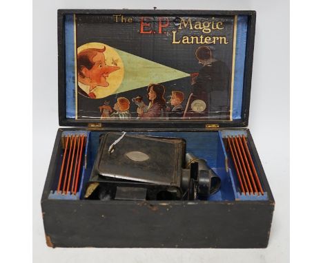 From the Studio of Fred Cuming. Vintage E.P. magic lantern and slides, cased. Condition - fair Note: “This is an interesting 