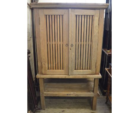 A large light Oak two door food hutch with slatted panels, width 38 1/2", depth 33" and height 64" (all measurements approxim