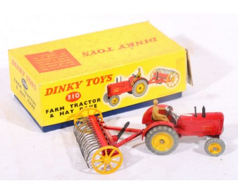 Dinky Toys 310 farm tractor and hay rake, the Massey-Harris tractor with red body and yellow hubs, boxed with packing piece.