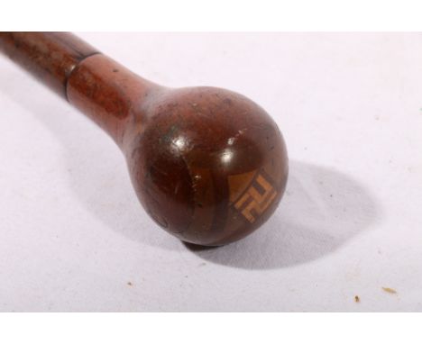 Nazi German influenced walking stick, the pommel parquetry inlaid with swastika, 98cm.