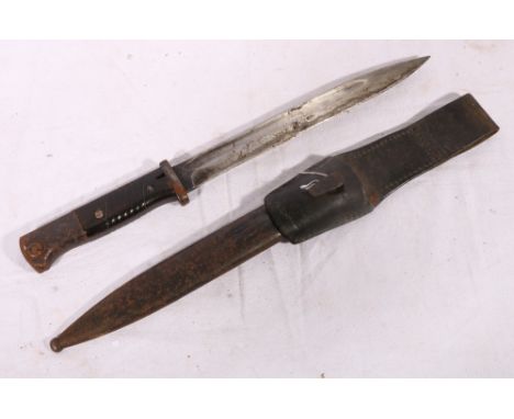 German S84/98 bayonet, the ricasso stamped Berg & Co., blade back stamped 40, bakelite grips, the scabbard with matching numb