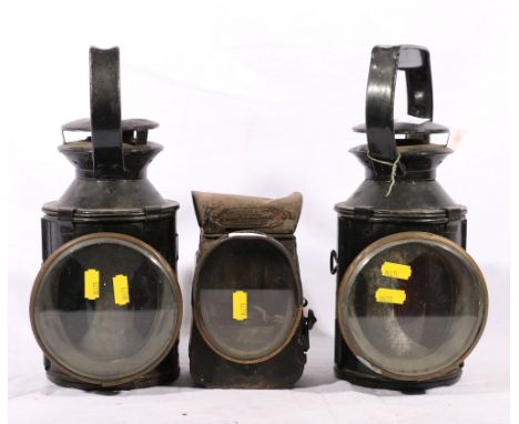 Two British Railway BR lanterns and a Lucas & Son King of the Road lamp.