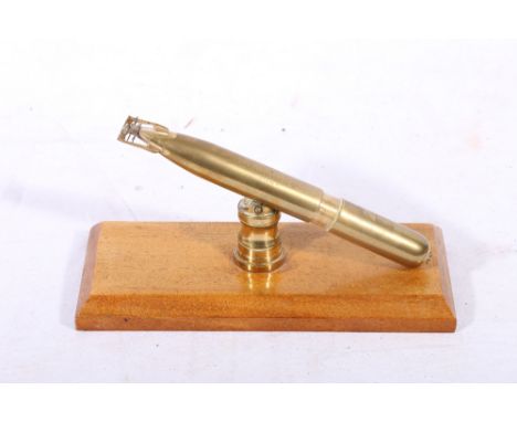Brass desk lighter in the form of a torpedo with presentation inscription 'To Lieut Commander J M Findlay with best wishes fr