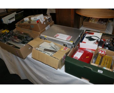 N gauge model railway layout accessories including track, trees, buildings, kits, packs, tools, etc., in nine large boxes.