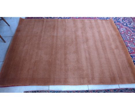 A rust ground woolen contemporary carpet - 2.30m x 1.60m