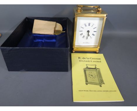 An English brass cased carriage clock, Roman numeral to white enamel dial
