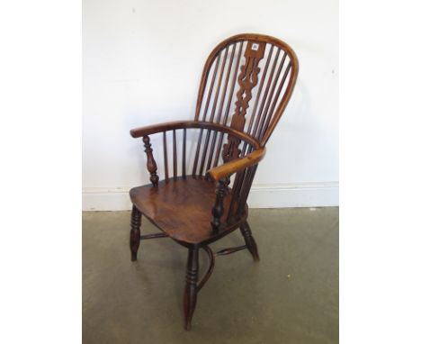 A 19th century yew and elm low seated stick back chair with a crinoline stretcher - Height 91cm - seat height 35cm 