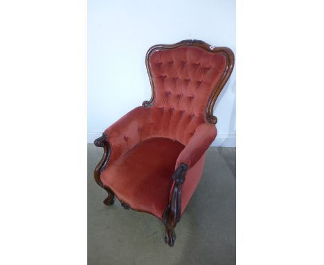 A 19th century mahogany button back armchair on fine cabriole legs