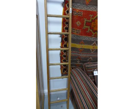 A vintage ladder, eight rungs, waxed for decorative use