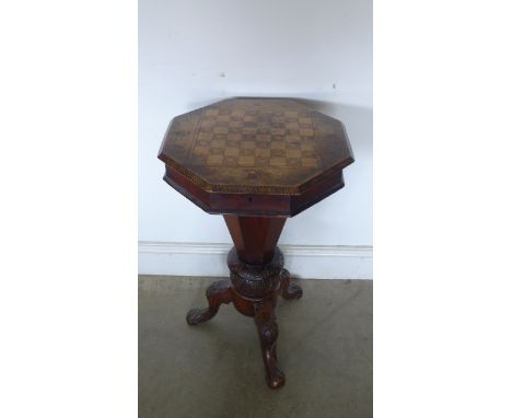 A 19th century walnut needlework box on stand the top inlaid with games board, the interior empty raised on carved tripod bas