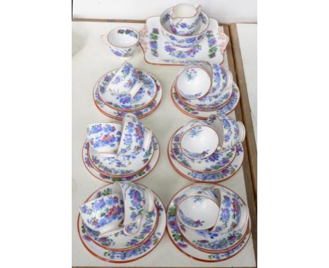 A WEDGWOOD BONE CHINA TEA SERVICE, PRINTED IN BRIGHT BLUE AND ENAMELLED WITH CHINESE PLANTS, THE RIM OUTLINED IN RED ENAMEL, 