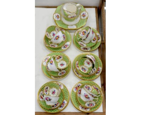 AN APPLE GREEN GROUND BONE CHINA TEA SERVICE, PROBABLY STAFFORDSHIRE, PRINTED AND PAINTED WITH GROUPS OF FLOWERS IN TRELLIS B