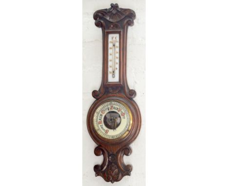 A CARVED OAK ANEROID BAROMETER WITH MERCURY THERMOMETER, 57CM H, C1900 AND AN OCTAGONAL OAK MIRROR WITH BEVELLED PLATE