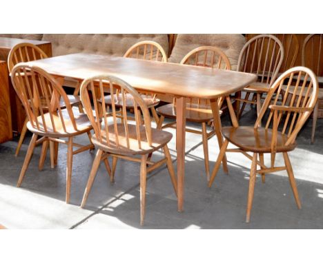AN ERCOL WINDSOR FIXED TOP DINING TABLE, 153 X 74CM AND A SET OF SIX ERCOL DINING CHAIRS INCLUDING TWO ELBOW CHAIRS