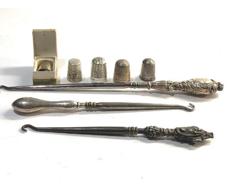 Selection of silver items includes thimbles and button hooks 