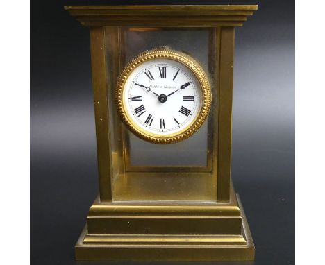Mathew Norman brass and glass mantle clock, with a Swiss movement. 15 cm high x 11 cm wide. UK Postage £15. 