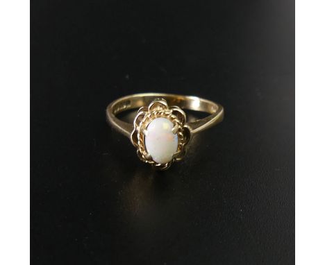 9 carat gold opal set ring, size K. Top 10 mm wide and the band is 2.2 mm wide. UK Postage £10 