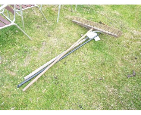 A wide brush and two rakes.