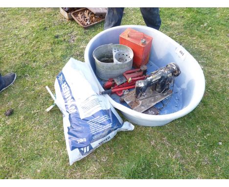 A dog bed with Esso Petrol 2 gallon can , galvanised mop bucket, Singer sewing machine, and a bath shower mixer.