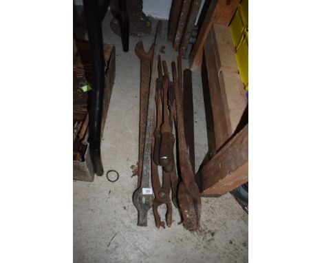 A selection of blacksmiths metal working tongs and similar large spanner etc