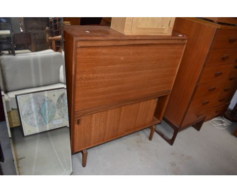 A vintage teak bureau with bookcase under having fall flap and sliding doors, width approx. 92cm
very good condition, two min