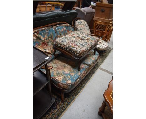 A dark stained Ercol cottage suite comprising settee, chair and footstool