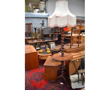 An early 20th Century mahogany standard lamp with integral side table, twist column and triple splay legs