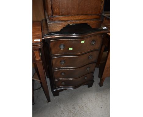 A reproduction bow fronted chest of four doors