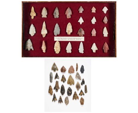 TWO DISPLAYS OF STONE ARROWHEADS one display of arrowheads stated to be from Dagenham, Essex, with twenty-three probably Neol