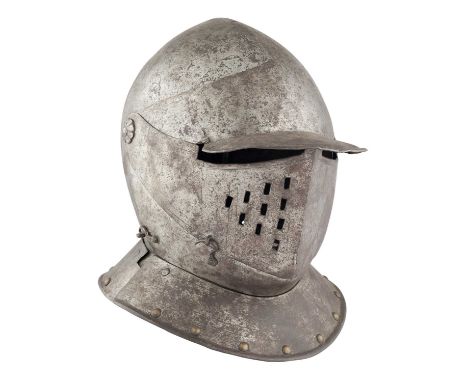 A NORTH ITALIAN CLOSE HELMET, FIRST QUARTER OF THE 17TH CENTURY  ‡ with rounded one-piece skull rising to a low medial ridge 