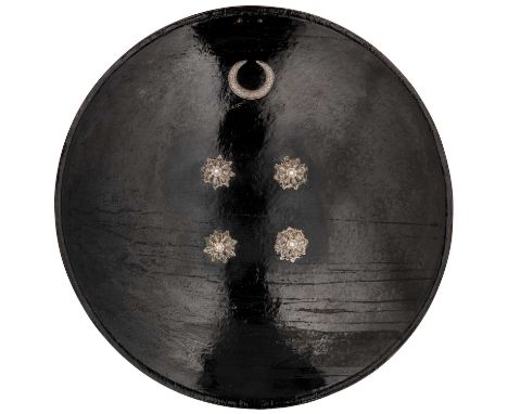 A NORTH INDIAN LAQUERED SHIELD (DHAL), 19TH CENTURY, PERHAPS SIND  of concave form curved outwards at the brim, lacquered ove