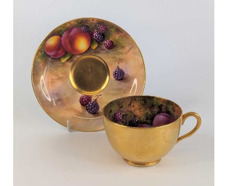 A Royal Worcester tea cup and saucer, circa 1938, hand painted with fruit and signed by Edward Townsend, saucer dia.14cmThe g