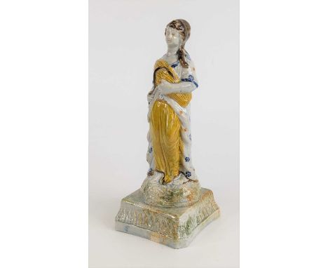 A Prattware figure of a lady, early 19th century, emblematic of Autumn, upon a canted plinth, h.23cmCrazed all over.Two chips