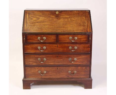 A George III mahogany slopefront writing bureau, the crossbanded fall opening to reveal fitted interior with pigeonholes over