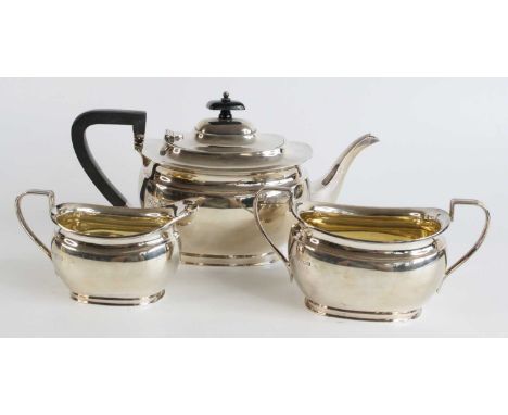 A George V silver three-piece tea service, comprising teapot with ebonised wooden reeded handle and finial, single reeded han