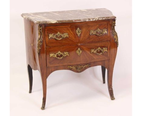 A 19th century French provincial walnut bombe commode, having a veined rouge marble top, two frieze drawers with gilt metal e
