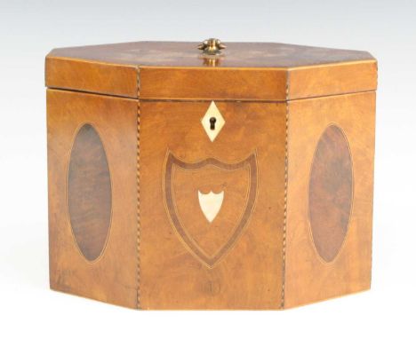 A George III mahogany tea caddy, of elongated octagonal form, having ebony and boxwood chequer stringing, inlaid oval roundel