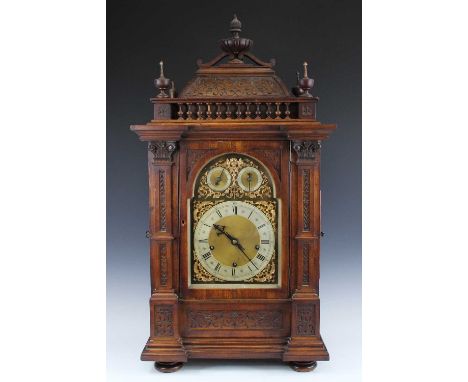A late 19th century walnut cased musical bracket clock, of good size, with bracket, having unsigned arched brass dial with Ro