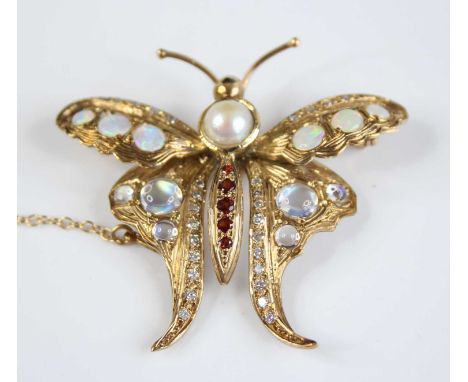 An Arts &amp; Crafts style yellow metal multi-stone butterfly brooch, featuring a 6mm pearl set in the thorax, four round gar