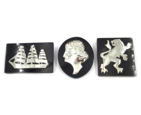 Three silver mounted ebonised plaques depicting a sailing ship, lion and female portrait, two hallmarked N.S.N. Birmingham 19