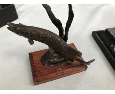 A bronze model of a pike amongst reeds on wooden base