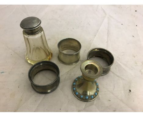 Hallmarked silver napkin rings; together with a turquoise squat candlestick